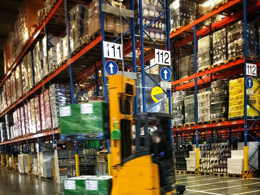 Forklift moving a pallet in a warehouse